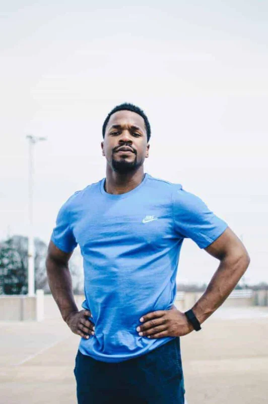 Mann mit einem blauen T-Shirt während der Pause in einer Fitnessübung